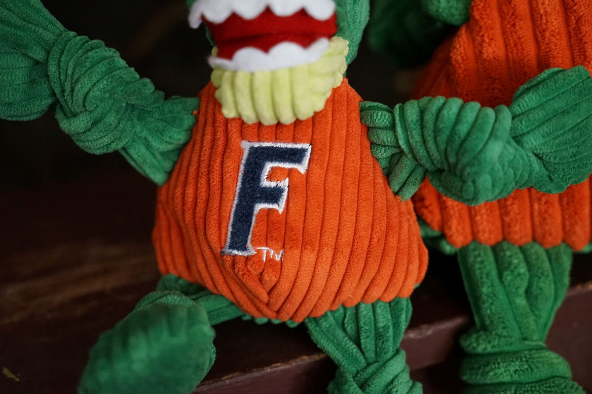 Albert Gator Knottie close-up of the embroidered navy F on the orange corduroy shirt