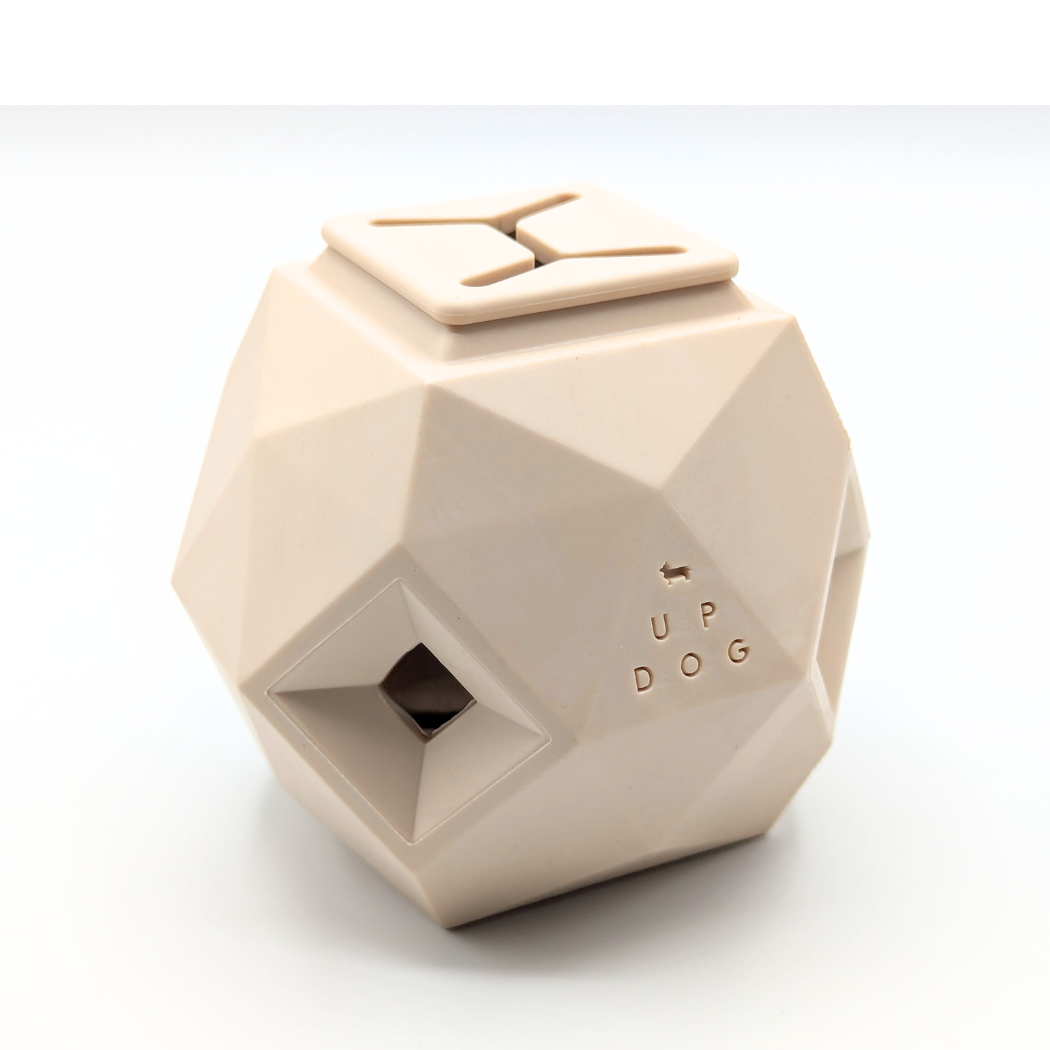 Up Dog Odin Treat Puzzle Ball in natural sand, angled view on a white background