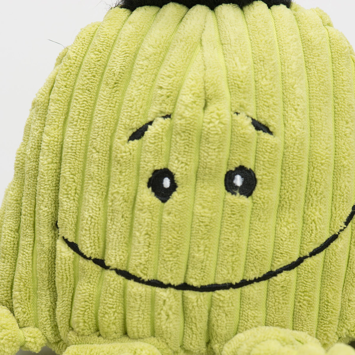 Octavie Octopus Knottie close-up of the lime green Large's stitched smile and raised eyebrows