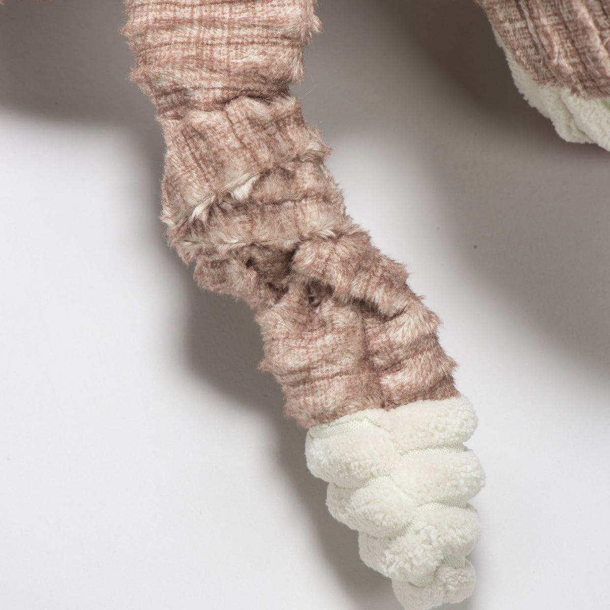 Stuey Sock Monkey Knottie close-up of a knotted brown corduroy limb ending in a cream cuff