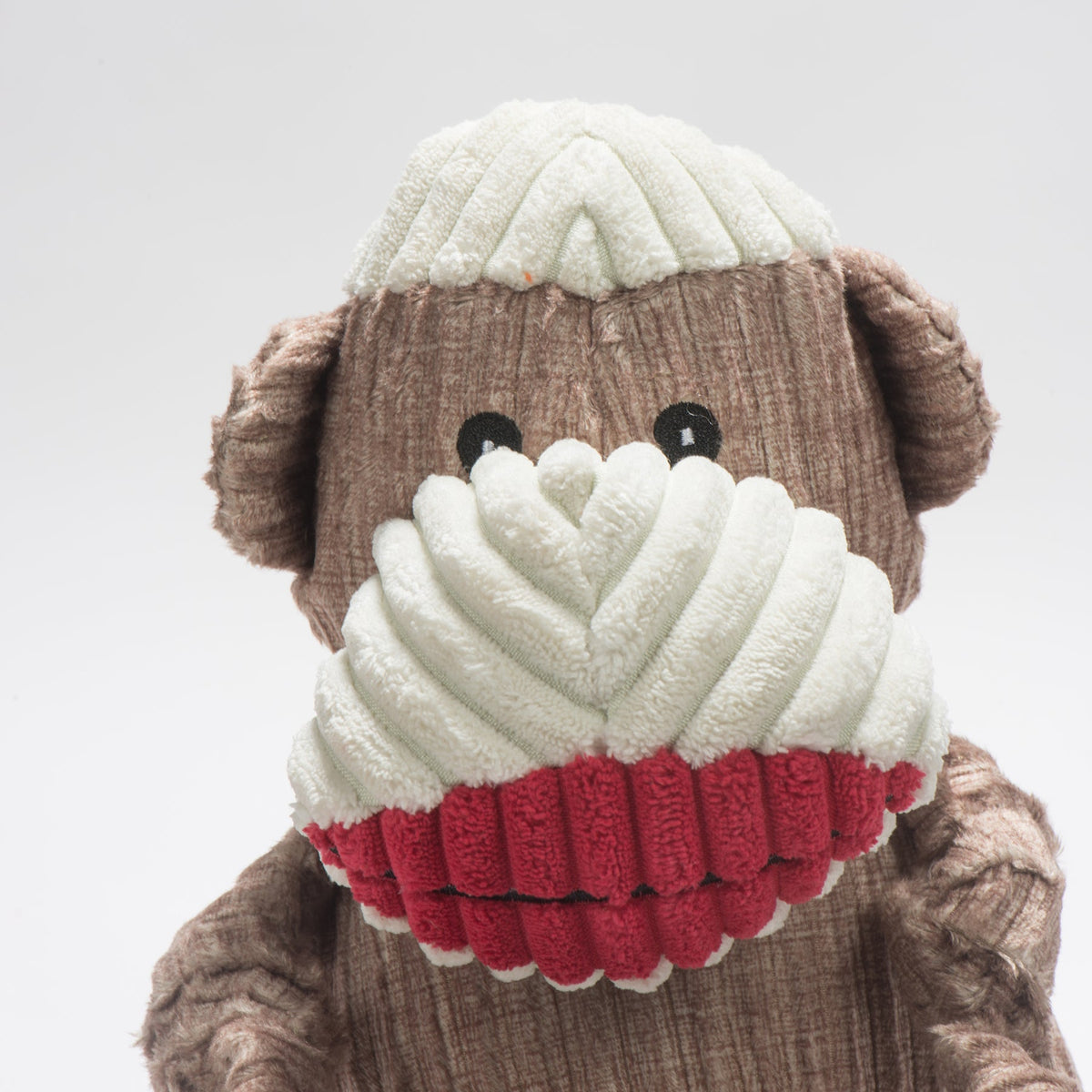 Stuey Sock Monkey Knottie face close-up, black embroidered eyes, cream corduroy muzzle and red lips