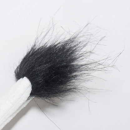 Dottie Cow Knottie close-up of the fuzzy black tuft at the end of its white corduroy tail