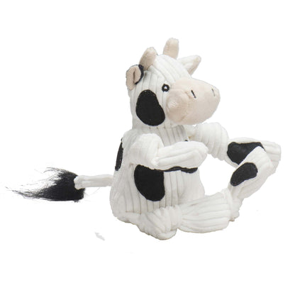 HuggleHounds Dottie Cow Knottie plush dog toy on white, side view of the spotted white corduroy and black tail tuft