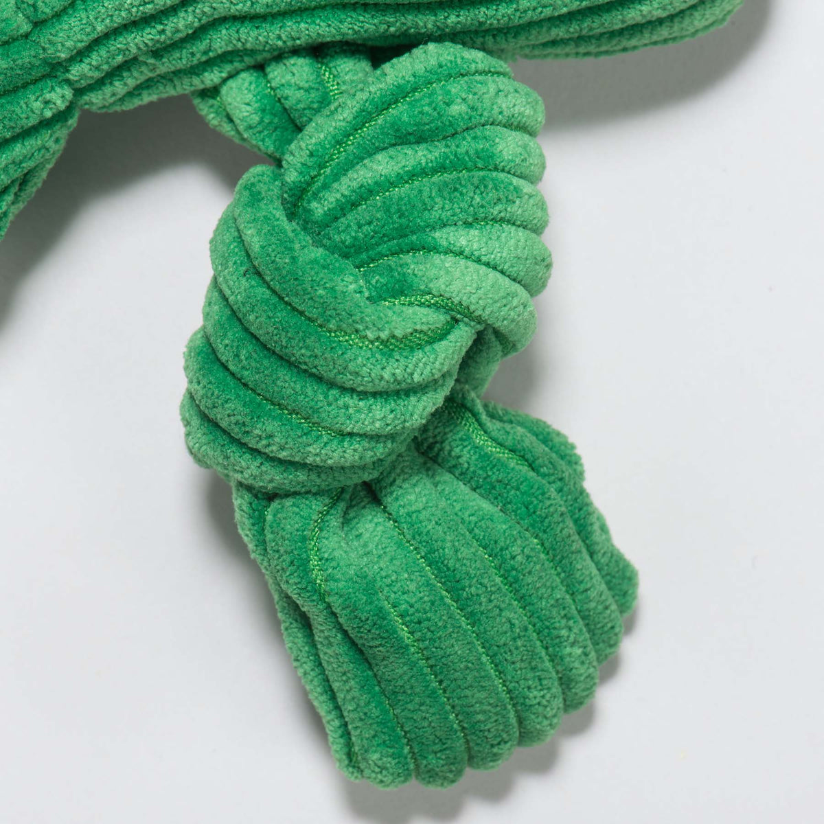 Fergie Frog Knottie close-up of a knotted green corduroy leg