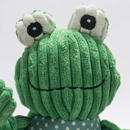 Fergie Frog Knottie close-up of the white bug eyes and wide stitched grin on green corduroy