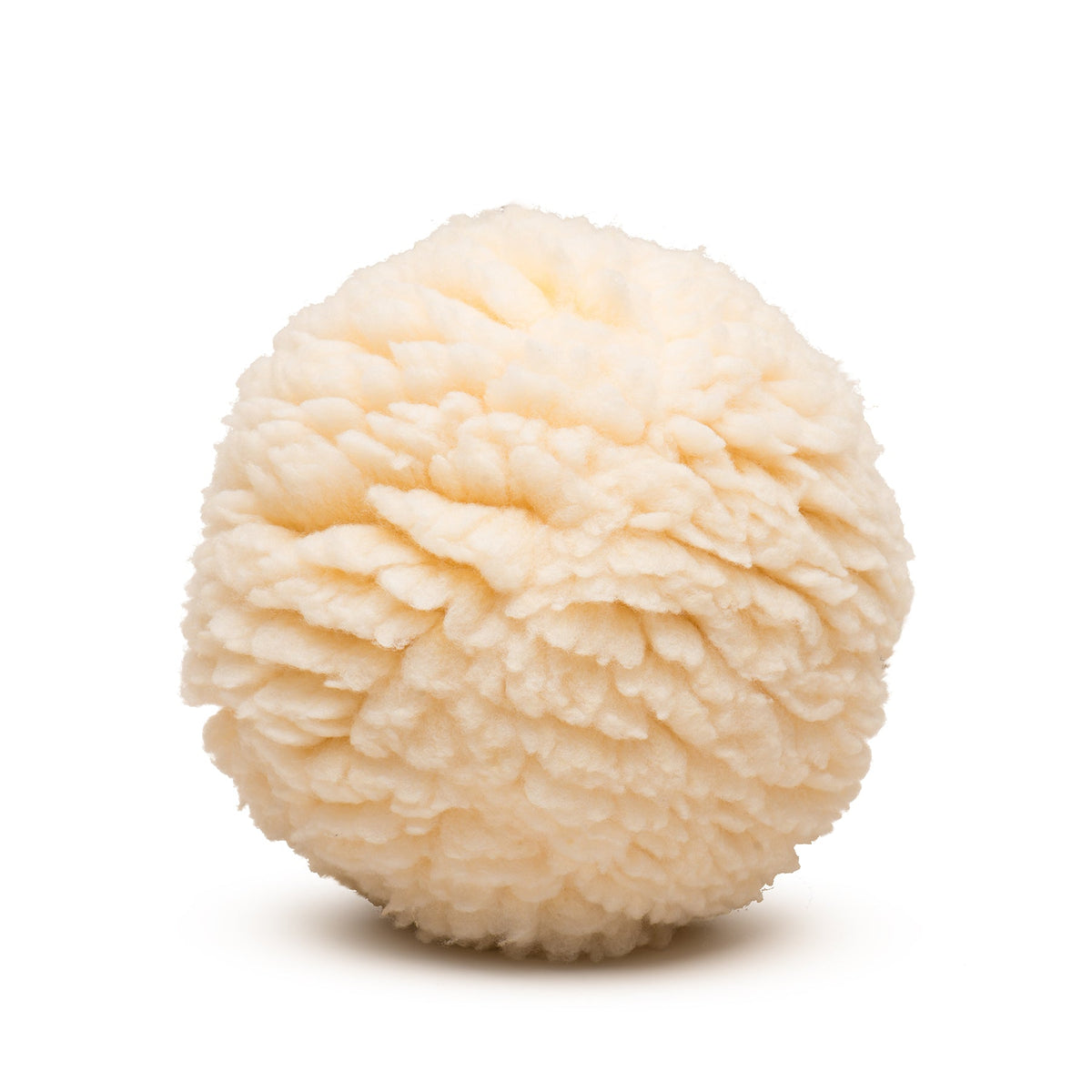 Close-up of the HuggleFleece Plush Ball's dense, curly cream fleece, with no seams showing