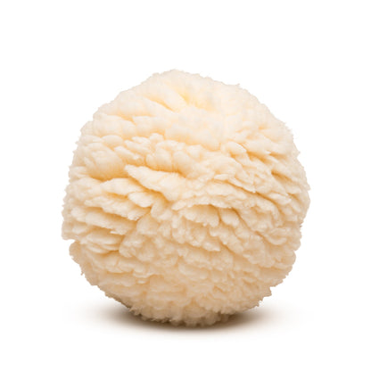 Close-up of the HuggleFleece Plush Ball's dense, curly cream fleece, with no seams showing