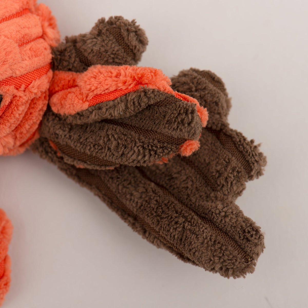 Close-up of the moose Flattie's brown plush antlers and orange corduroy ear