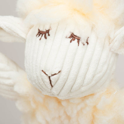 Louise Lamb plush close-up of her cream corduroy face, embroidered closed eyes and nose under a fleece tuft