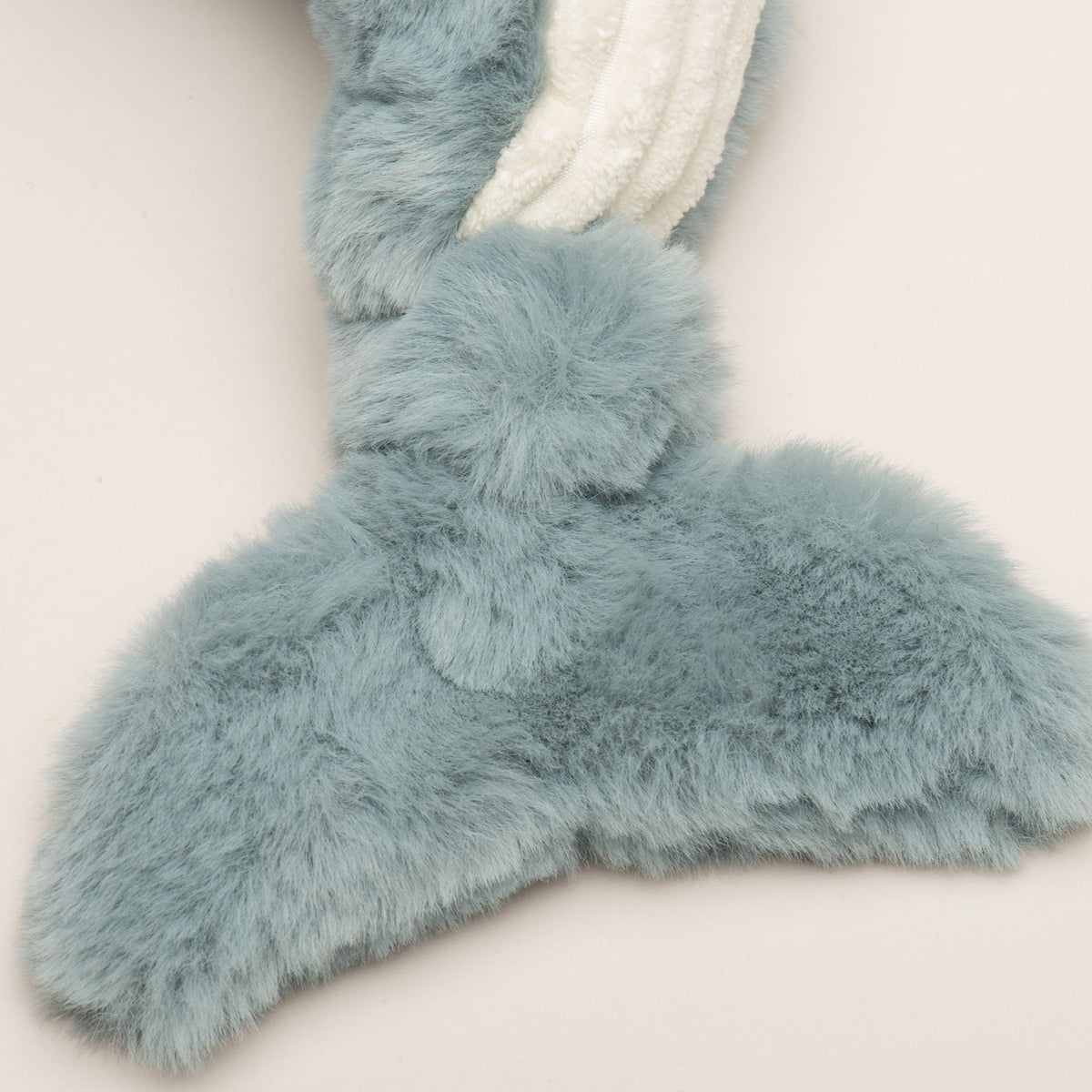 Mobie Whale Wee Huggles tail close-up, gray faux fur fluke with a knot where it joins the body