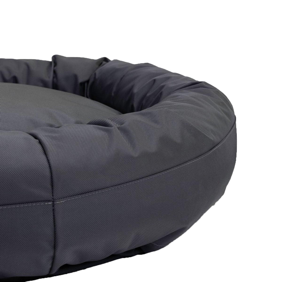 Round Bolstered Armor dog bed in charcoal, close-up of the stuffed rim and its stitched seam