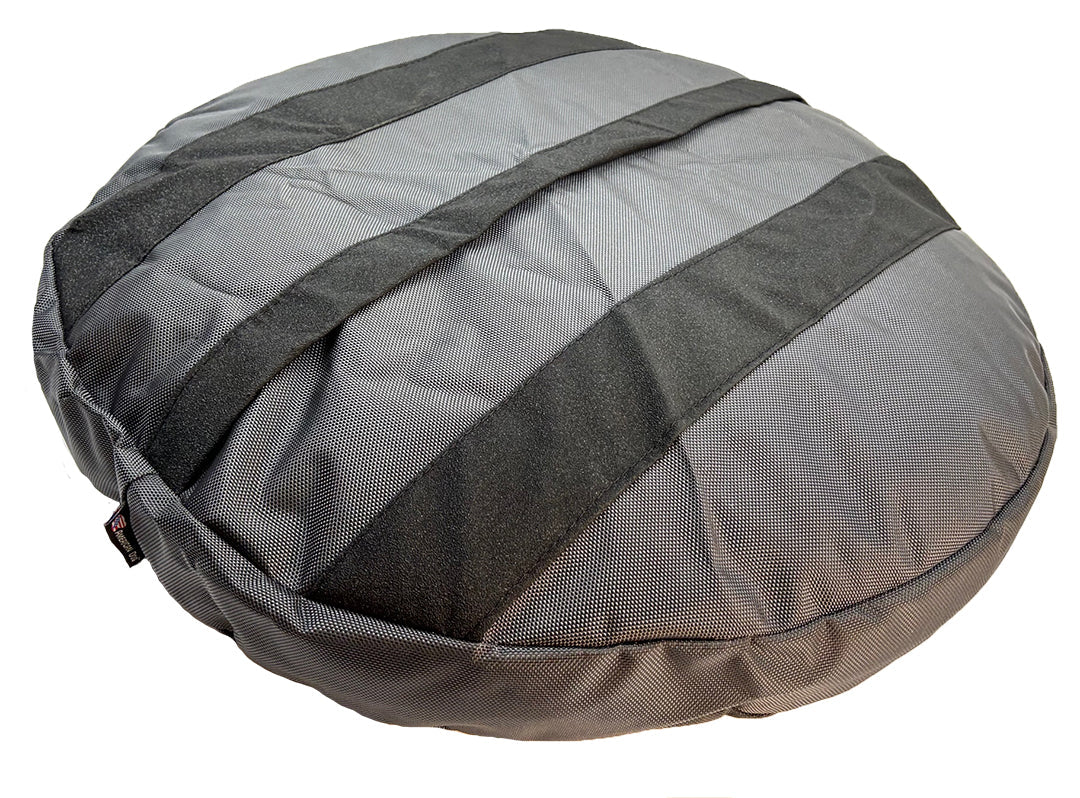 Underside of a gray Round Armor dog bed showing the non-skid strips across the base
