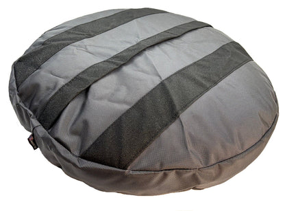 Underside of a gray Round Armor dog bed showing the non-skid strips across the base