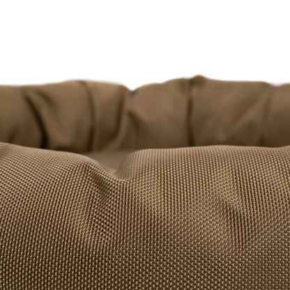 Round Bolstered Armor dog bed in camel, close-up of the ballistic nylon weave on the rim