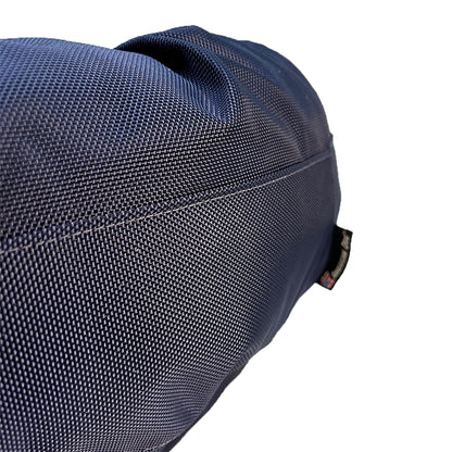 Round Bolstered Armor dog bed in midnight navy, close-up of the ballistic nylon weave and side seam
