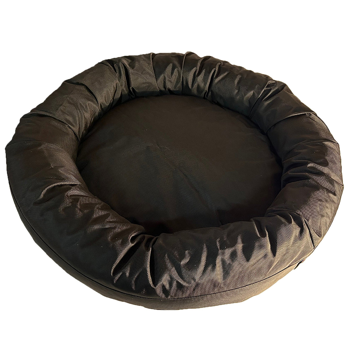 Round Bolstered Armor dog bed in black seen from above, showing the round center cushion inside the rim