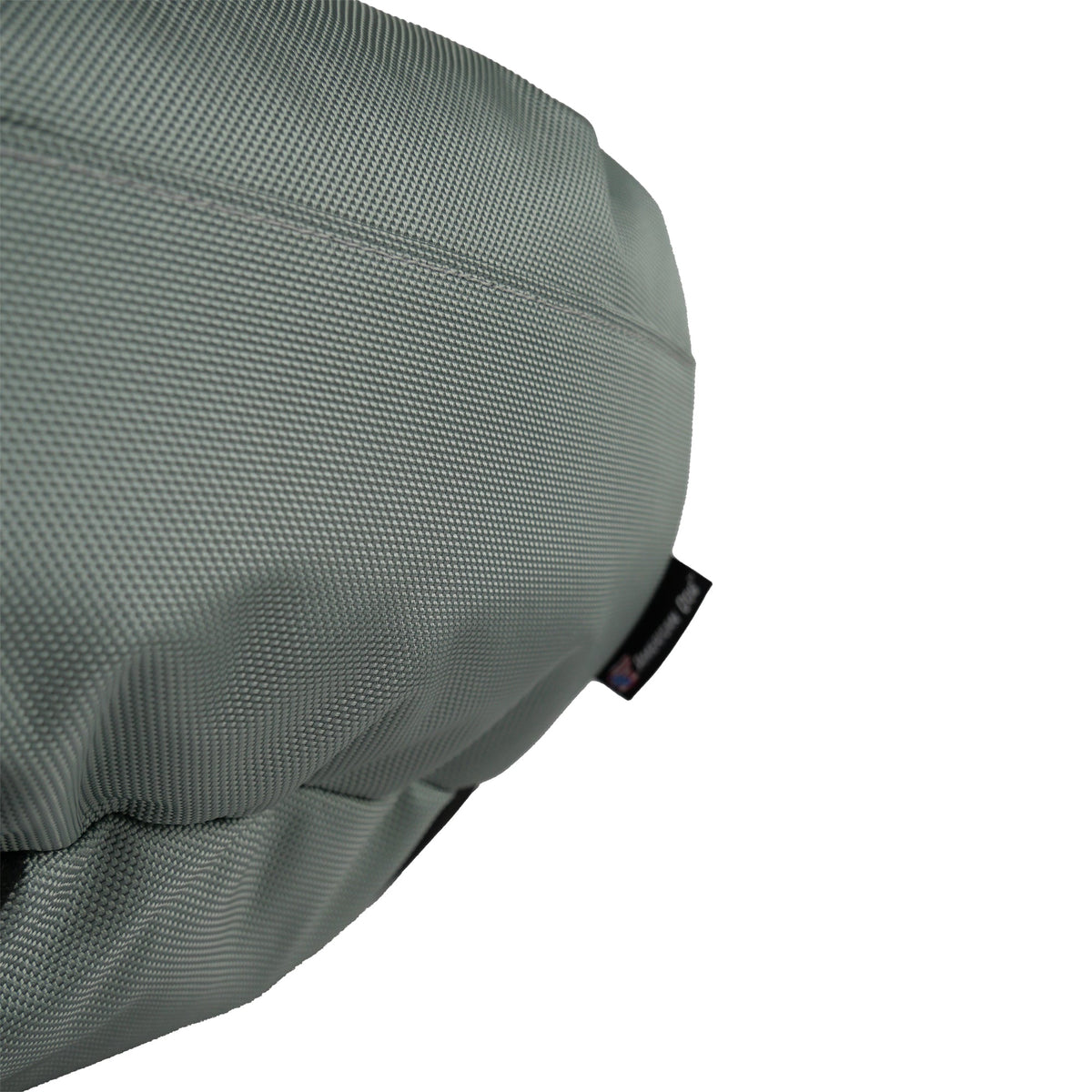 Round Bolstered Armor dog bed in silver gray, close-up of the side seam and American Dog label