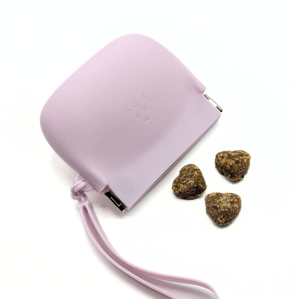 Up Dog One-Hand Treat Pouch in purple, top-down view beside three heart-shaped soft dog treats