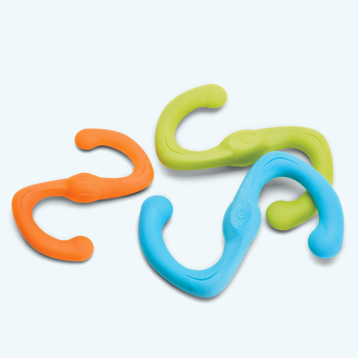 Three Bumi tug toys in tangerine, granny smith green, and aqua blue, overlapping