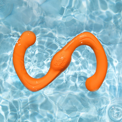 Tangerine Bumi tug toy floating in clear pool water