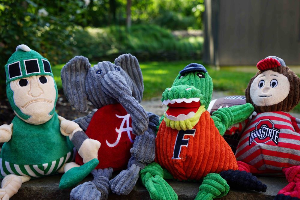 Brutus Buckeye Knottie outdoors in a row with the Michigan State, Alabama and Florida Knotties, each sold separately