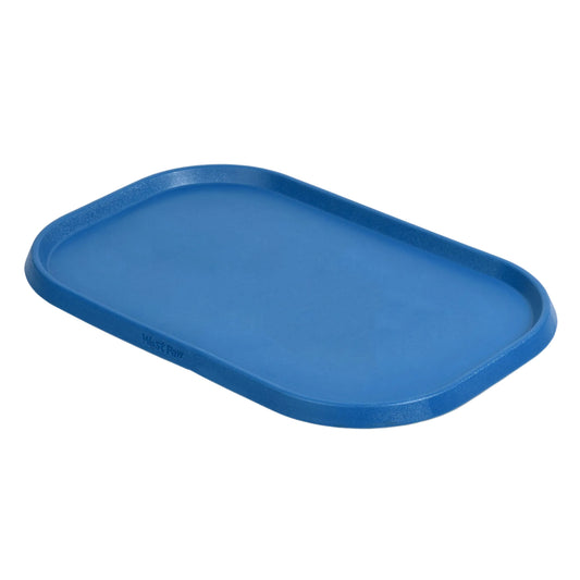 West Paw Non-Slip Placemat in marine blue, a rimmed rectangular dog feeding mat, angled view