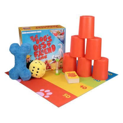 West Paw Dog's Best Friend Game, a family dog game, laid out with stacked cups, plush bone and die, timer, cards and mat