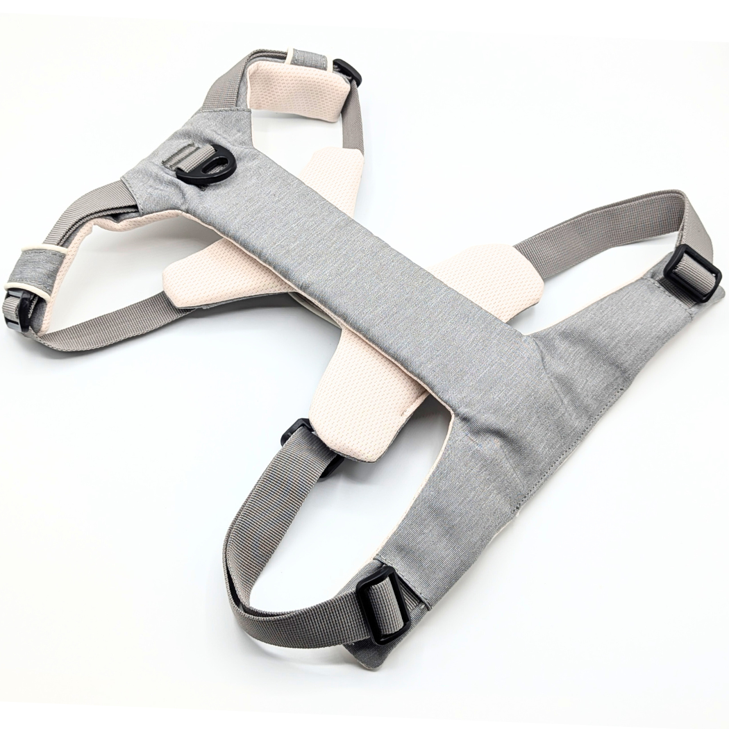 Gray Up Dog harness laid flat face down, showing the chest plate, front D-ring, and adjustable straps