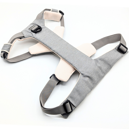 Gray Up Dog harness laid flat face down, showing the chest plate, front D-ring, and adjustable straps