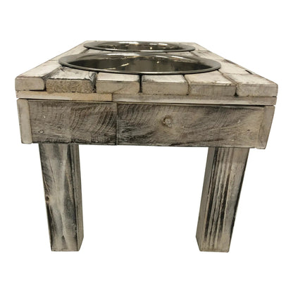 End view of the white wash Berjen raised dog feeder showing its square wooden legs and the tabletop edge