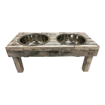 Front view of the white wash raised dog feeder from slightly above, two stainless bowls side by side