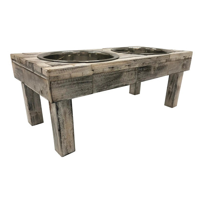 Low side angle of the white wash wooden raised dog feeder, showing the leg spacing underneath