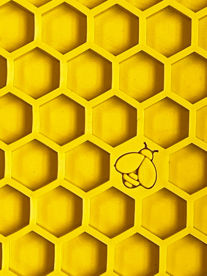 Close-up of the yellow SodaPup Honeycomb eMat surface showing the hexagon cells and embossed bee