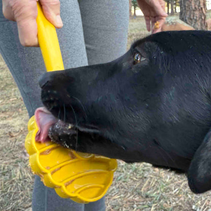 eStick in the yellow beehive design, close-up of a black dog's tongue licking spread off the textured head