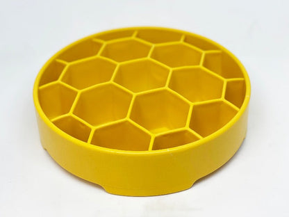 Empty yellow SodaPup Honeycomb eBowl from an angle above, showing the depth of each hexagon cell