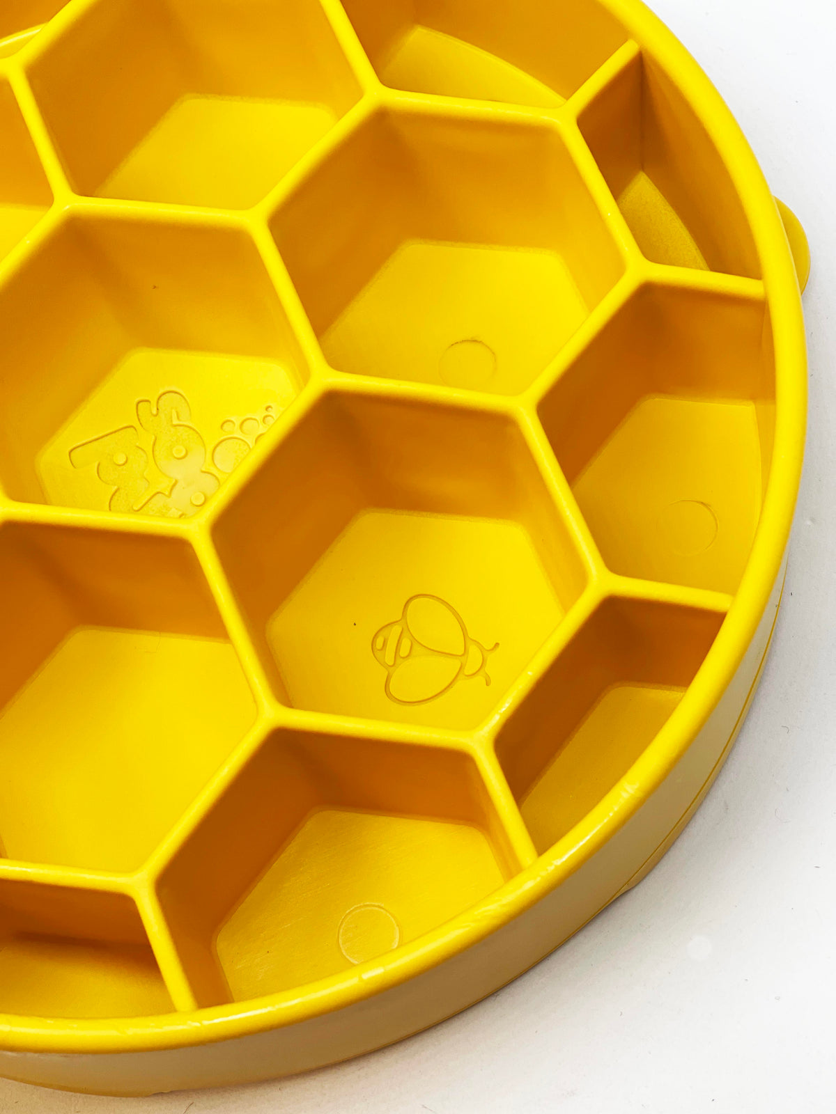 Close-up of the yellow SodaPup Honeycomb eBowl cells with the embossed bee and SodaPup logo