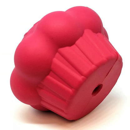 Cupcake treat dispenser tipped over to show the ridged wrapper and the small air hole in its base