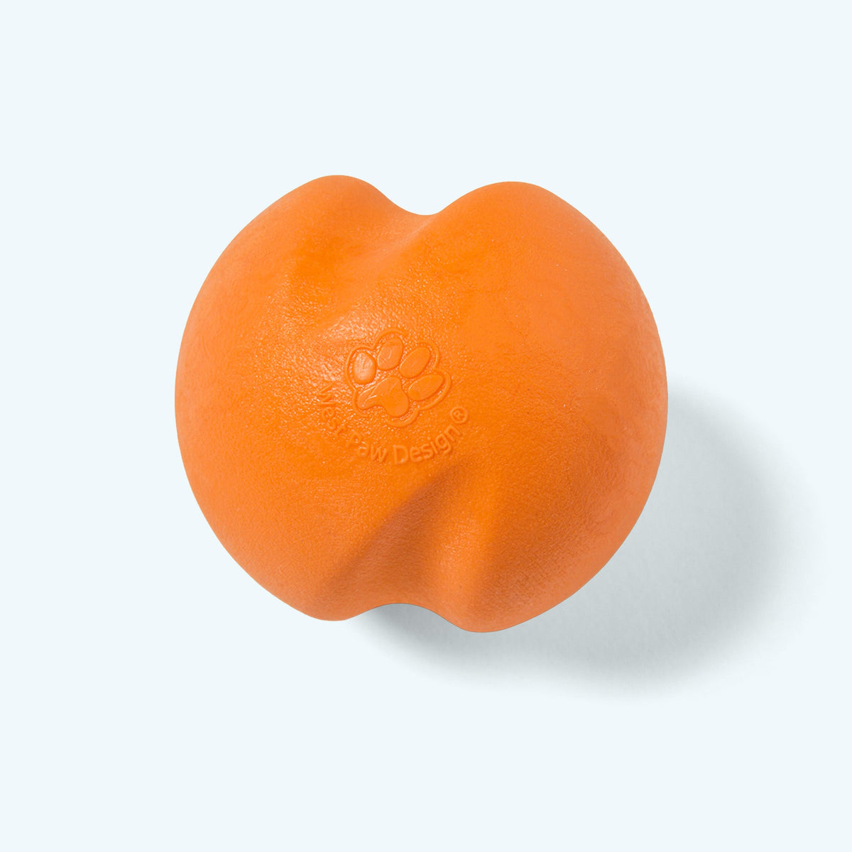 Tangerine Jive ball, angled view with the embossed paw print, on a pale blue background