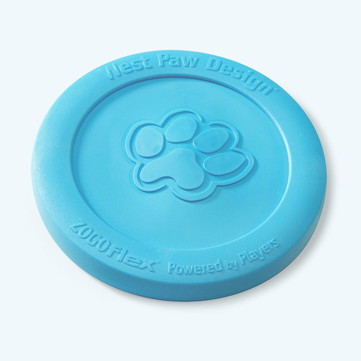 West Paw Zisc flying disc in aqua blue, lying flat at an angle to show the raised outer rim