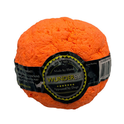 Orange WUNDERball with its round Made by Hand label, showing the lumpy textured rubber surface