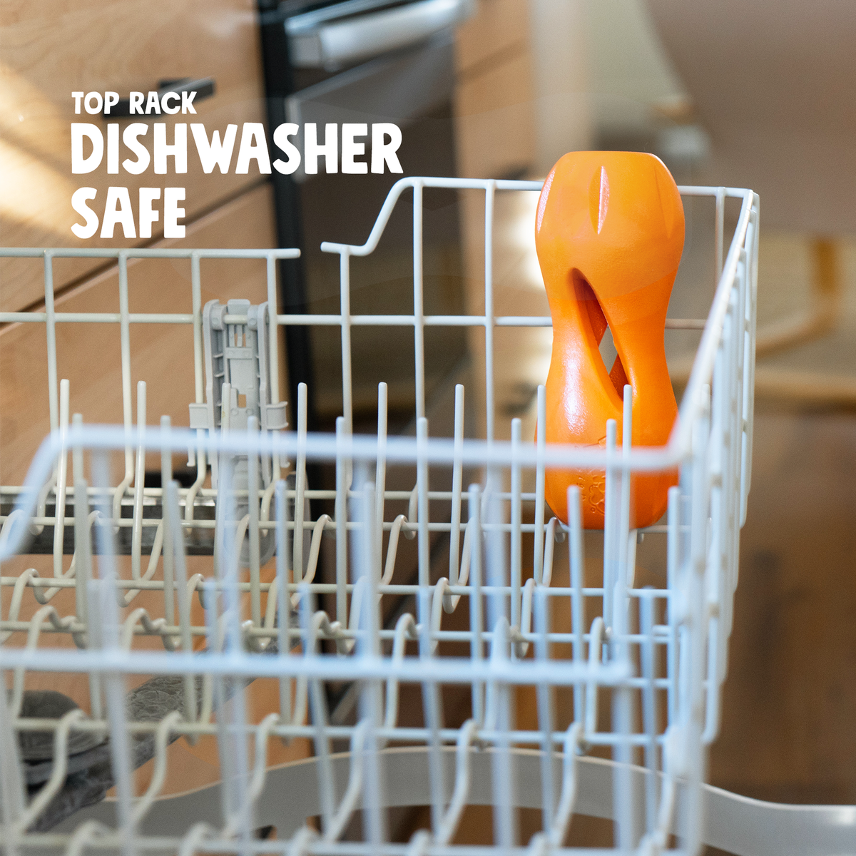 Tangerine Qwizl standing in the top rack of a dishwasher