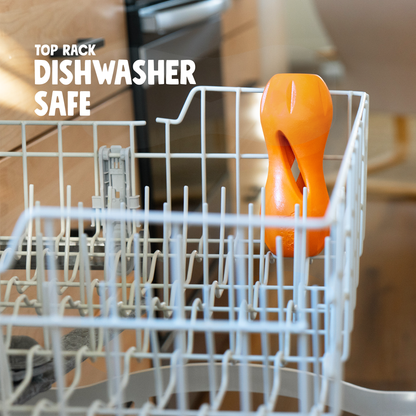 Tangerine Qwizl standing in the top rack of a dishwasher