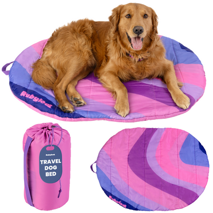 Packable travel dog bed in Pink Horizon, Medium, with a golden retriever lying on the pink and purple stripes
