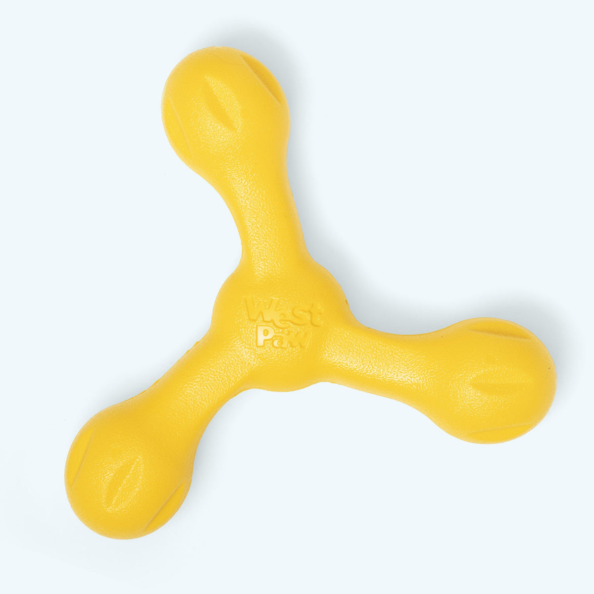 Skamp fetch toy in dandelion yellow, top view of the three arms and West Paw logo