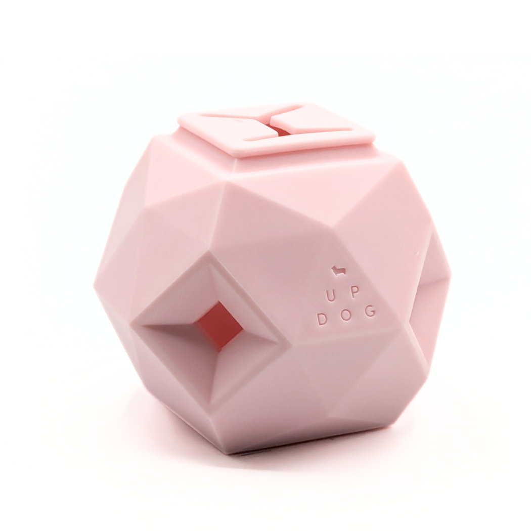 Up Dog Odin Treat Puzzle Ball in rose quartz, angled view on a white background