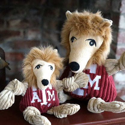 Reveille Knottie dog toy in two sizes sitting together on a wooden shelf by a brick wall