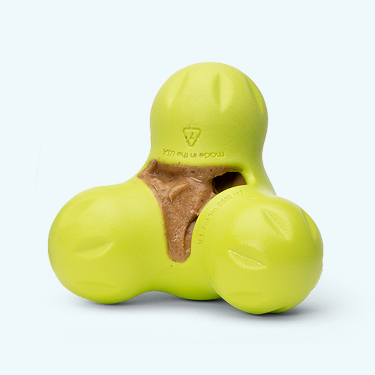 Tux treat toy in granny smith green with a spread smeared into the pocket, angled view