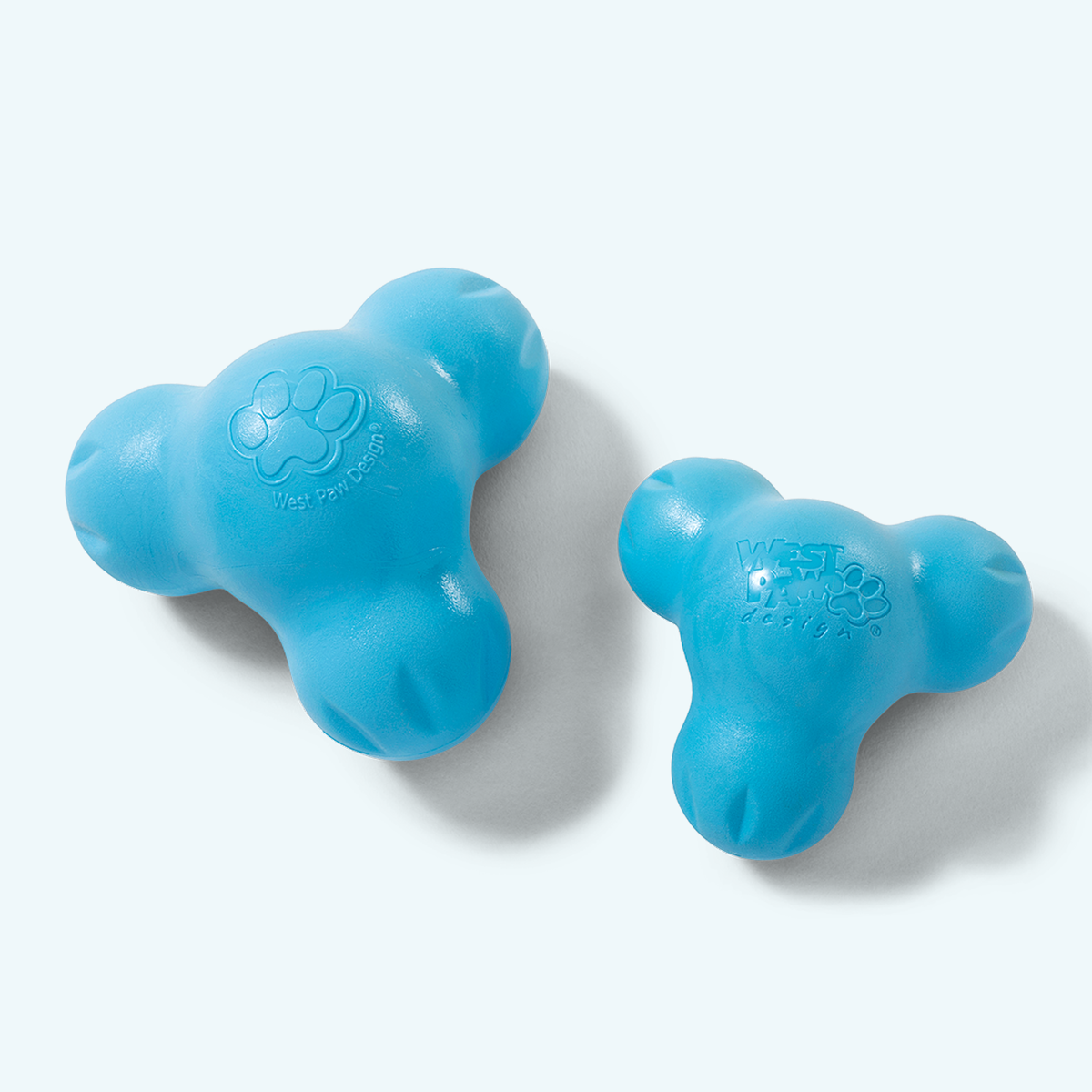 Tux treat toys in aqua blue in two sizes, back view of the solid side with the paw print logo