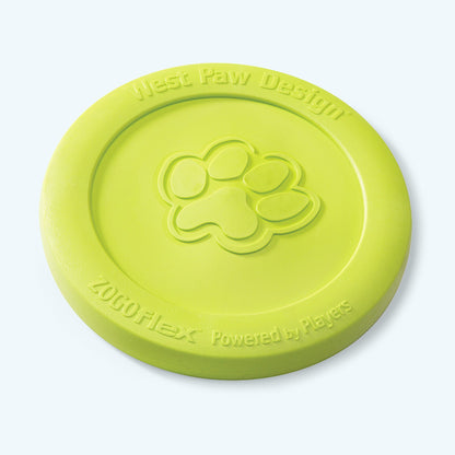 West Paw Zisc flying disc in granny smith green, lying flat at an angle with the embossed paw print
