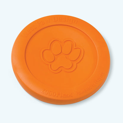 West Paw Zisc flying disc in tangerine orange, lying flat at an angle with the embossed paw print
